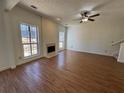 Inviting living room with wood floors, fireplace, and plenty of natural light at 2979 Belfaire Crest Ct, Dacula, GA 30019