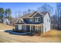 Well-maintained two-story home with a manicured lawn and mature trees in a desirable neighborhood at 50 Crabapple Ridge Dr, Oxford, GA 30054