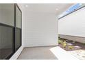 Covered patio area with ample space and a view of the adjacent side yard at 528 Pearl St, Cumming, GA 30519