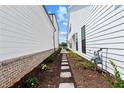 Narrow landscaped side yard with stepping stones and plants between two homes at 528 Pearl St, Cumming, GA 30519