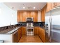 Modern kitchen with stainless steel appliances, granite countertops, and dark backsplash at 1080 Peachtree St # 2116, Atlanta, GA 30309