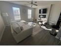 Bright living room with hardwood floors, a modern ceiling fan, and abundant natural light at 1852 Laurel Green Way, East Point, GA 30344