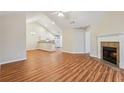 Bright open-concept living room featuring a fireplace, hardwood floors, and vaulted ceilings at 302 Gladstone Dr, Mcdonough, GA 30253