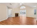 Bright living room showcasing hardwood floors, vaulted ceilings and inviting fireplace at 302 Gladstone Dr, Mcdonough, GA 30253