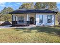 Charming one-story home showcasing a welcoming front porch and manicured lawn at 501 Harris Ave, Palmetto, GA 30268