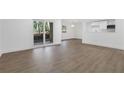 Living area features wood flooring, white walls, sliding glass doors to the outside and an opening to the kitchen at 2396 Lawrenceville Hwy # V, Decatur, GA 30033
