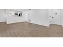 Living area features wood flooring, white walls, access to the kitchen and a door to the outside at 2396 Lawrenceville Hwy # V, Decatur, GA 30033