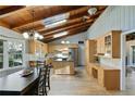 Eat-in kitchen with stainless steel appliances, center island, wood-beamed vaulted ceiling and lots of sunlight at 6275 Hunting Creek Rd, Atlanta, GA 30328
