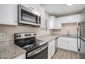Kitchen with granite countertops, stainless steel appliances, and white cabinets at 542 Oak Hills Sw Rd, Mableton, GA 30126
