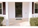 Close up of a front entrance with white pillars and a black door at 566 Sugar Valley Lane, Conyers, GA 30094