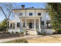 Charming two-story home with a columned front porch, black framed windows, and well-maintained landscaping at 818 Springdale Ne Rd, Atlanta, GA 30306