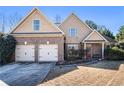Beautiful two-story home with a brick facade, two-car garage, and a welcoming front entrance at 8000 Abington Dr, Locust Grove, GA 30248