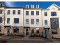 Charming townhouse with brick accents and a well-maintained front yard under a blue sky at 1121 Larkin Dr # 50, Buford, GA 30518