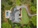 Aerial view of estate featuring a swimming pool, lush landscaping, and circular driveway at 581 Fairfield Nw Rd, Atlanta, GA 30327