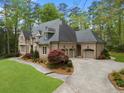 Expansive brick home with a three-car garage and beautifully landscaped grounds at 581 Fairfield Nw Rd, Atlanta, GA 30327