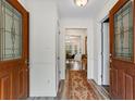 Inviting foyer with wood-look flooring and a decorative runner, leading to a dining area at 9635 Loblolly Ln, Roswell, GA 30075