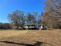 Charming single-story home with a large front yard and covered carport at 5559 John Burruss Rd, Cumming, GA 30040