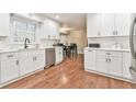 Bright white kitchen featuring modern cabinets, stainless steel appliances, and hardwood floors at 1830 Greystone Ct, Marietta, GA 30068