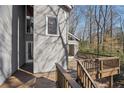 Exterior shot of a wood deck with gray house in the background and stairs leading down at 566 Hickory Hills Ct, Stone Mountain, GA 30083