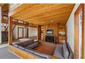 Spacious living area featuring a cozy fireplace, wood paneled walls, and an open staircase at 566 Hickory Hills Ct, Stone Mountain, GA 30083