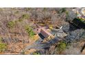 Aerial view of home surrounded by trees, showcasing the driveway and detached garage at 2499 E Maddox Rd, Buford, GA 30519