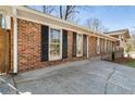 Charming brick home with classic shutters, complemented by a well-manicured lawn and concrete driveway at 3640 Hickory Se Cir, Smyrna, GA 30080