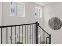 Modern staircase showcasing black railings and white walls, with natural light at 201 New St # 2301, Decatur, GA 30030