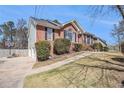 Lovely exterior view with a basketball hoop and a driveway leading to the home and an attached garage at 2101 Oakleaf Ln, Lithia Springs, GA 30122