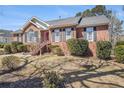 Inviting brick home with manicured landscaping, classic shutters, and a cozy outdoor space at 2101 Oakleaf Ln, Lithia Springs, GA 30122