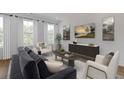 Comfortable living room featuring neutral decor, hardwood floors and large windows at 201 New St # 2305-1, Decatur, GA 30030