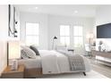 Bright bedroom with large windows, a comfortable bed, and a dedicated workspace by the window at 201 New St # 2305-1, Decatur, GA 30030