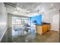 Sunlit living room with large windows, concrete floors, and an open layout leading to the kitchen at 845 Spring Nw St # 322, Atlanta, GA 30308
