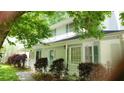View of the home's exterior featuring a long front porch with a white railing and a colorful teal front door at 3875 Wintergreen Ct, Marietta, GA 30062