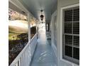 Covered porch with a white railing, pendant lights, and seating, perfect for enjoying the view at 3875 Wintergreen Ct, Marietta, GA 30062