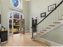 Elegant foyer featuring a detailed stained glass window above the front door and soaring ceilings at 715 Newport Holw, Alpharetta, GA 30005