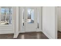 Bright entryway with white trim, wood-look flooring, and a glass-paneled front door at 814 Harmony Rd, Temple, GA 30179