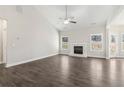 Spacious living room features wood-look floors, a fireplace, vaulted ceilings, and natural light at 814 Harmony Rd, Temple, GA 30179