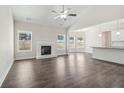 Open living room with fireplace flows into the kitchen with breakfast bar and modern finishes at 814 Harmony Rd, Temple, GA 30179