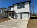 Two-story home features a two-car garage, white siding, black trim, covered porch and concrete driveway at 2108 Boxwood Circle Se, Conyers, GA 30094