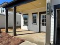 The covered front porch features dark pillars, white trim, a white front door, and the house number at 2108 Boxwood Circle Se, Conyers, GA 30094