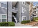 Close-up of the condo's entrance featuring the number 3, gray siding, and manicured shrubs at 3103 Santa Fe Pkwy, Atlanta, GA 30350