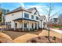 Charming home boasts a welcoming front porch, beautiful landscaping, and well-maintained lawn at 805 Dempsey Ct, Marietta, GA 30064