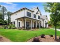 Inviting two-story home with a covered porch, manicured lawn and lovely landscaping at 805 Dempsey Ct, Marietta, GA 30064