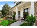 Inviting front porch with classic columns, lush landscaping, and a cozy seating area at 805 Dempsey Ct, Marietta, GA 30064