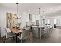 Contemporary kitchen featuring a dining area with modern chandelier and a large island with seating at 201 New St # 1102-8, Decatur, GA 30030