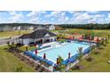 Community pool view showcasing lounge chairs, umbrellas, the clubhouse, and a playground at 165 Aster Avenue, Locust Grove, GA 30248