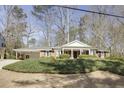 Charming brick home featuring a classic design, inviting front porch, and a well-manicured front yard at 18 Brandon Ridge Dr, Sandy Springs, GA 30328