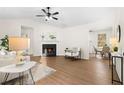 Bright living room featuring a fireplace, hardwood floors and neutral decor at 247 Mandy Ct, Mcdonough, GA 30252