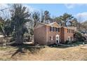 A lovely brick home with dark shutters and green foliage at 5293 Oakridge Dr, Stone Mountain, GA 30083