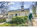 Classic brick home with well-maintained landscaping, a dark front door, and sidewalk access at 231 Peachtree Ne Way, Atlanta, GA 30305